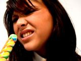 Erotic brunette amateur British schoolgirl Natalia sucking a long lollipop with lust